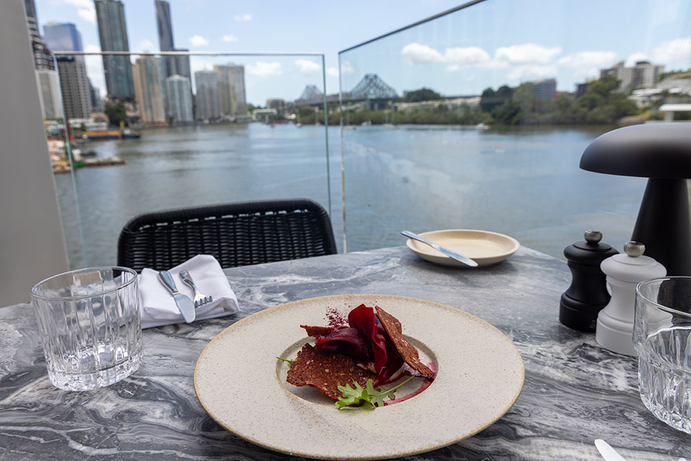 Stilts Dining Kangaroo Point Bridge Plate of food with view at Stilts Dining