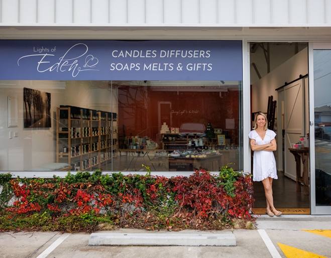 Woman standing outside Lights of Eden home fragrance and gift shop, Albion