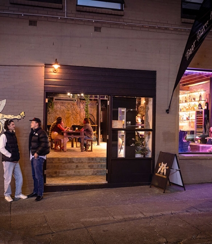 Bar Mesopotamia Milton People outside Bar Mesopotamia by night
