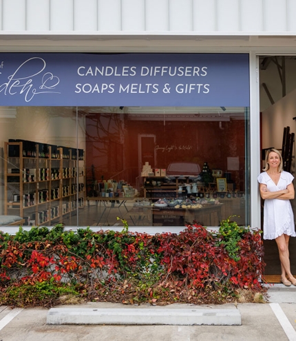 Woman standing outside Lights of Eden home fragrance and gift shop, Albion