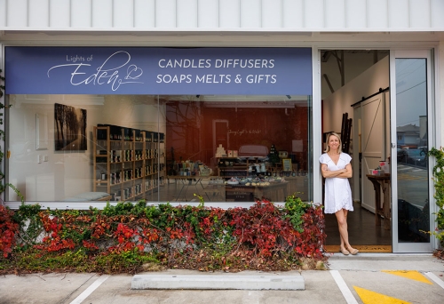 Woman standing outside Lights of Eden home fragrance and gift shop, Albion