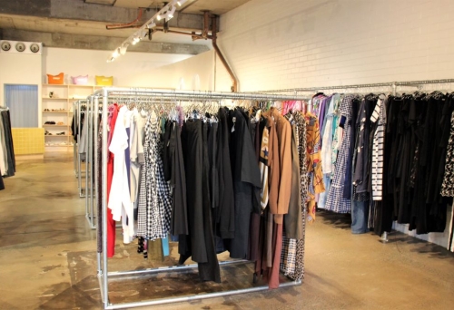 Racks of secondhand garments for sale inside SWOP, West End 