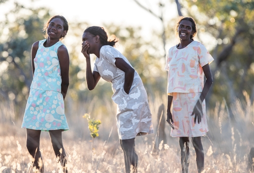 Three First Nations women wearing fashions by First Nations designers at Stories You Wear: Magpie Goose